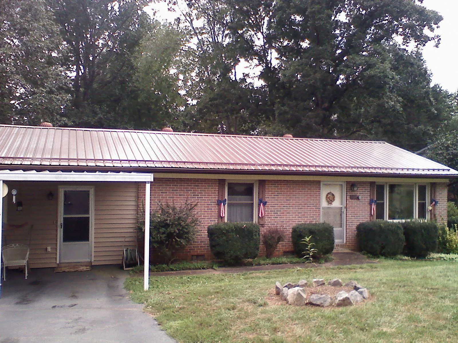 Bronze metal roof and carport on a brick ranch home — Roof Repair work by our crew in Pasadena